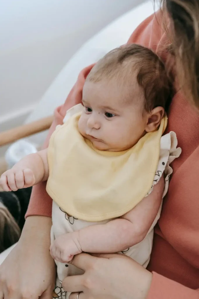 Mother keeping baby upright 