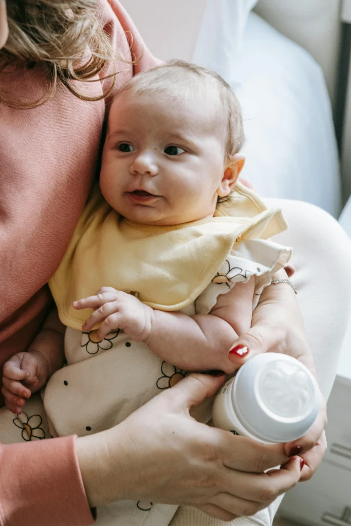 Mother burping baby during feeding 