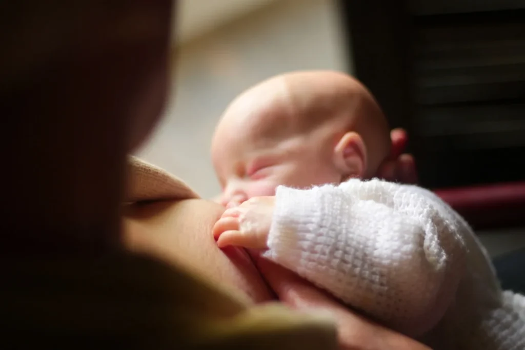 newborn baby breastfeeding during the first month